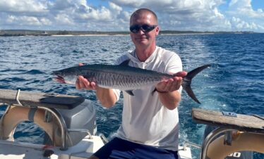 A traveller shows his fish after a deep fishing trip in Northern Mombasa