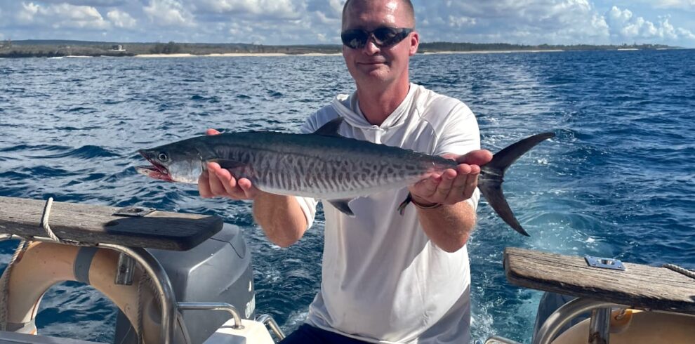 A traveller shows his fish after a deep fishing trip in Northern Mombasa